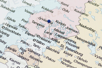 Macro photo of a blue pin needle into Kotka city of Finland political map 