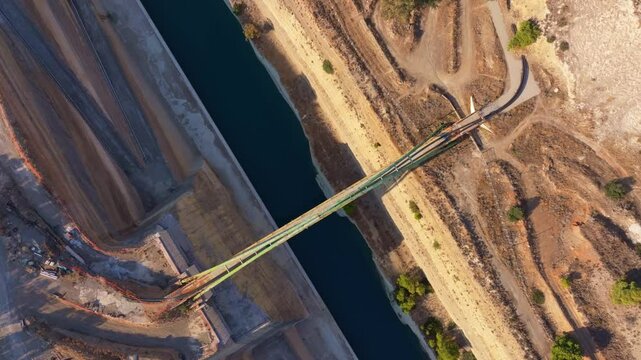 Aerial view of Corinth Canal with a beautiful bridge and scenic landscape, Corinth, Greece.