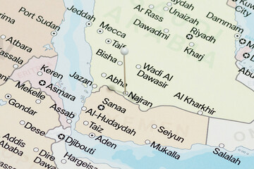 Macro photo of a white pin needle into Najran city of Saudi Arabia political map 