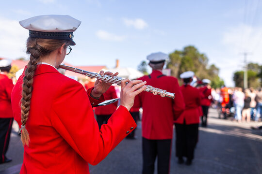 Flautist playing flute in ANZAC Day parade with local band