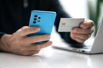 Man using credit card and paying via mobile banking app. Internet payment, online shopping, concept.
