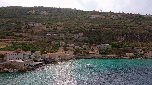 Aerial view of picturesque Limeni town with traditional stone buildings by the serene Mediterranean Sea, Peloponnese, Greece.