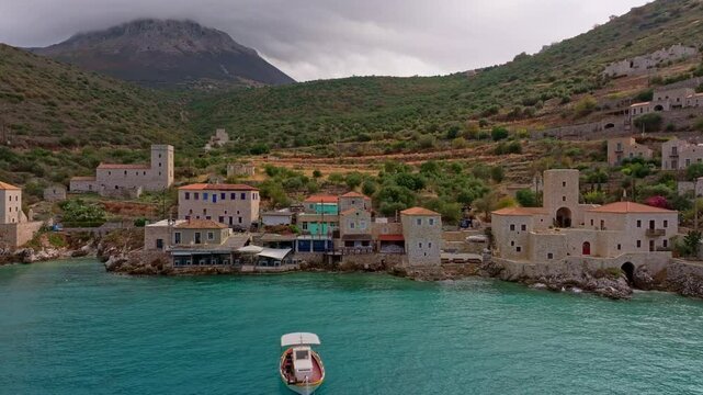 Aerial view of picturesque Limeni village with stone buildings and tranquil Mediterranean Sea, Peloponnese, Greece.