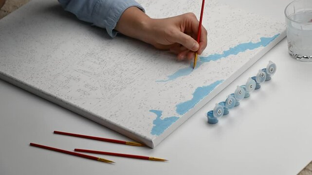 Woman paints a picture by numbers. Timelapse. Creative leisure. 