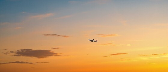 Airplane in the sky at sunrise or sunset