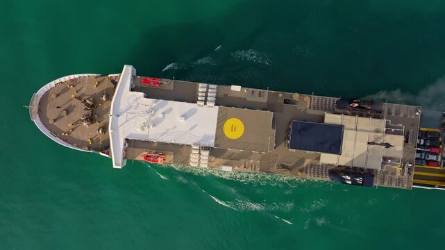Aerial view of a ferry crossing turquoise waters of the Ionian Sea, Kyllini, Greece.