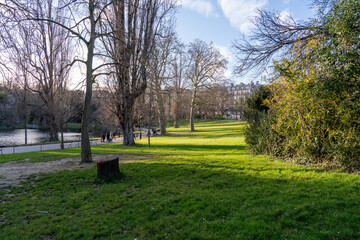 Exploring the serene beauty of Parc des Buttes-Chaumont in springtime under a clear blue sky