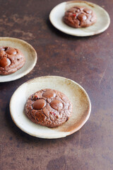 Homemade chocolate brownie  cookies on brown pottery plate.