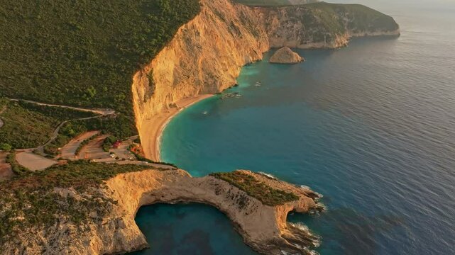 Aerial view of porto katsiki beach at sunset with cliffs and waves, lefkada, greece.