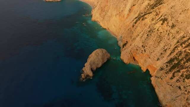 Aerial view of porto katsiki beach at sunset with rugged cliffs and azure waters, lefkada, greece.