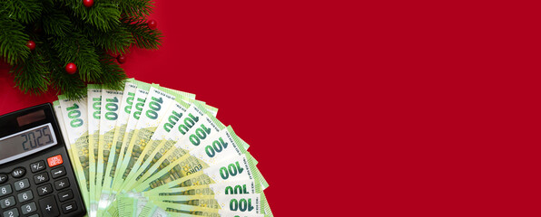Banner, 100 euro banknotes fan-folded, calculator with the inscription 2025 new year, copy space...