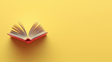 Colorful Open Book on Yellow Background