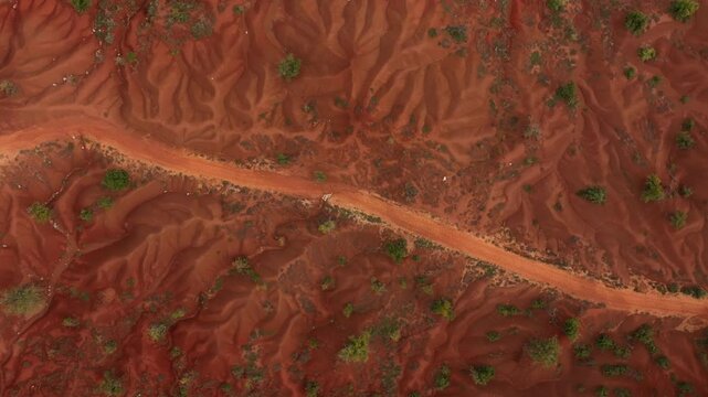 Aerial view of beautiful abstract landscape with winding road and red soil, Kokkinopilos Preveza, Greece.