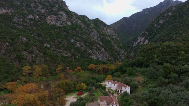 Aerial view of the majestic Acheron Springs and canyon with a serene river surrounded by lush greenery and rugged mountains, Epirus, Greece.