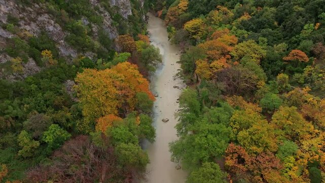 Aerial view of the winding river through the lush canyon with beautiful fall colors, Acheron Springs, Epirus, Greece.