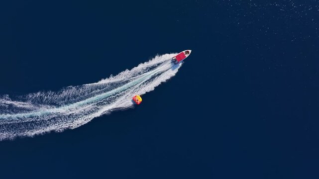 Aerial view of dynamic water sports with boats and parasailing over the beautiful Mediterranean Sea, Fethiye, Turkey.