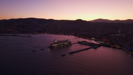 Kusadasi, Turkey - 01 December 2024: Aerial view of a serene coastline with a cruiseship at dawn, Kusadasi, Turkey.