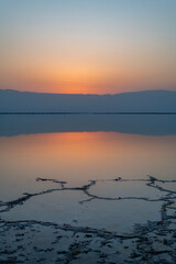 View of the brilliant colors of the Dead  Sea and the Jordanian mountains at sunrise  on a Winter's day in Israel.