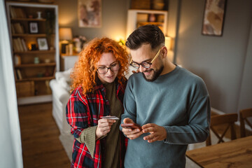 boyfriend and girlfriend use cellphone and credit card shopping online