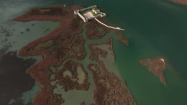 Aerial view of Ali Pasha's Castle on the island surrounded by tranquil Lake Butrint and beautiful wetlands, Ksamil, Albania.