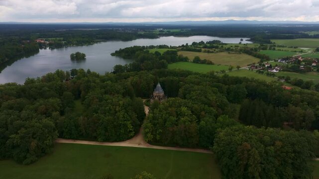 Aerial view of the serene Schwarzenberg tomb amidst lush greenery and tranquil lake, Trebon, Czech Republic.