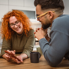 happy couple use mobile phone together and enjoy the slow morning