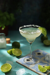 A glass with margarita cocktail with lime