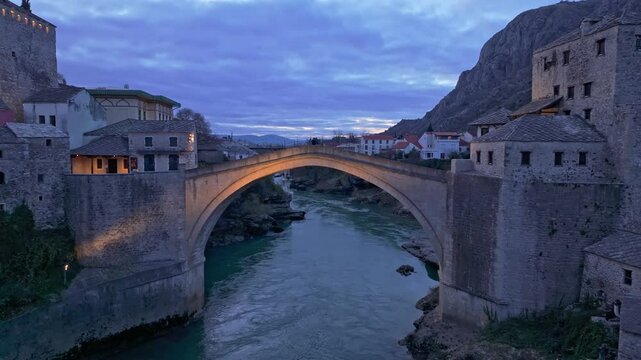 Aerial view of the historic Stari Most bridge over the scenic Neretva River at twilight, Mostar, Bosnia and Herzegovina.