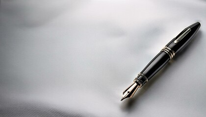 A black fountain pen diagonally positioned on a white canvas, with copy space in the corners.