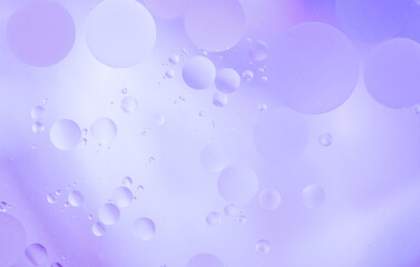 Beautiful cosmetic background. Liliac abstract oil bubbles or face serum background.