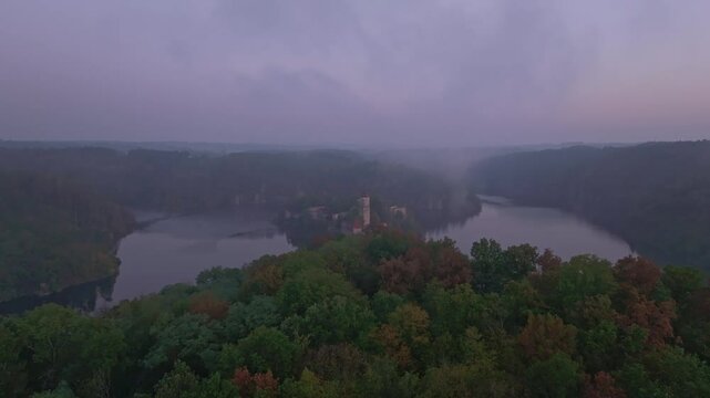 Aerial view of Zvikov Castle and the Moldau river at sunrise with misty forest, Zvikovske Podhradi, Czech Republic.