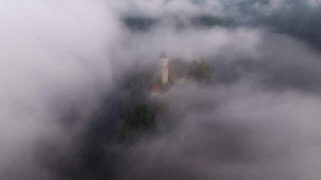 Aerial view of Zvikov Castle beside the Moldau river at sunrise with clouds and mist, Zvikovske Podhradi, Czech Republic.
