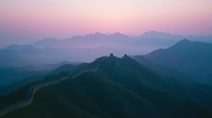 Obraz premium Majestic Great Wall winds through misty mountain range at sunrise