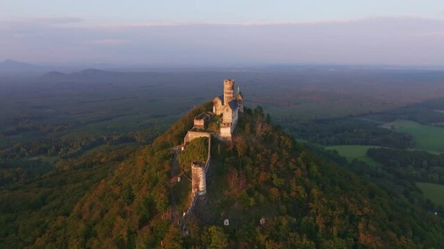 Aerial view of bezdez castle at sunset surrounded by forest and hills, bezdez, czech republic.