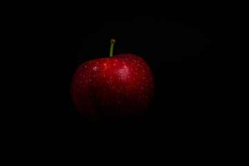 red apple on black background