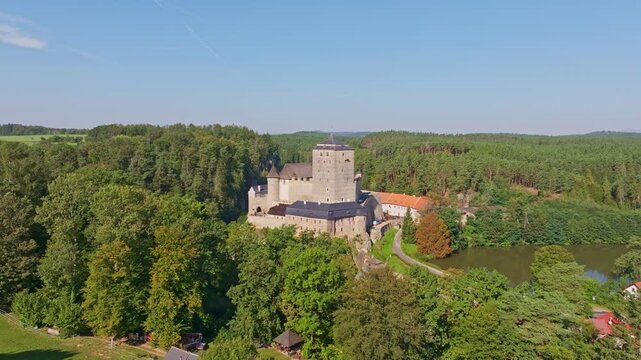 Aerial view of kost castle surrounded by lush forest and trees, Dobsin, Czech Republic.
