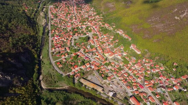 Aerial view of a beautiful village with historic rooftops and scenic landscapes by the Vit River, Glozhene, Bulgaria.