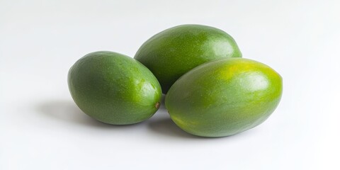 Obraz premium Fresh green mango isolated on a white background showcases the vibrant color and unique characteristics of the fresh green mango. This fresh green mango stands out beautifully in any composition.