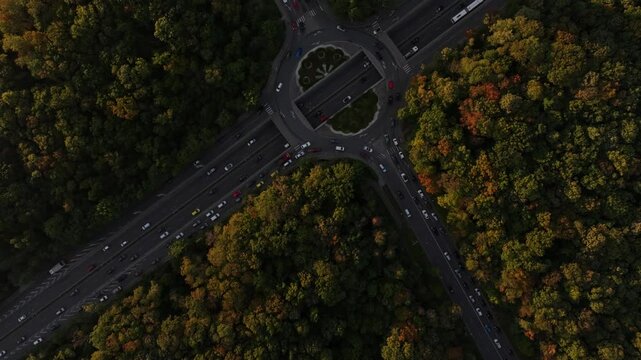 Aerial view of the beautiful Television Tower surrounded by a colorful autumn forest and busy roads at sunrise, Sofia, Bulgaria.