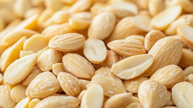 Close up view showcasing a pile of blanched almonds, highlighting the natural texture and color of the blanched almonds, perfect for culinary and health related visuals featuring blanched almonds.