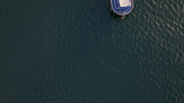 Aerial view of fishing vessel on the turquoise Black Sea at sunrise, Nesebar, Bulgaria.