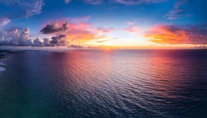 Obraz premium Stunning Ocean Sunset Aerial View Colorful Sky Dramatic Clouds Peaceful Seascape Tropical Paradise