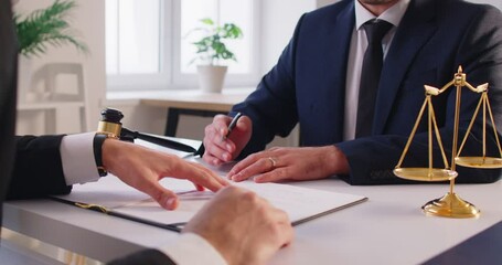 Close up shot of a lawyer or attorney working with a client during a meeting in an office, discussing legal documents, contract negotiations, and providing law services during conversation. - Powered by Adobe
