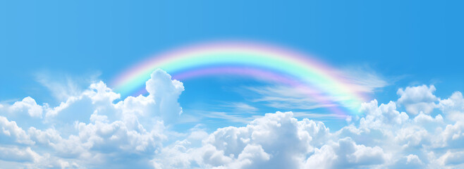 Make a wish on a rainbow spiritual message banner - big arcing translucent rainbow with blue sky and fluffy clouds, ideal for a spiritual holistic environmental theme template
