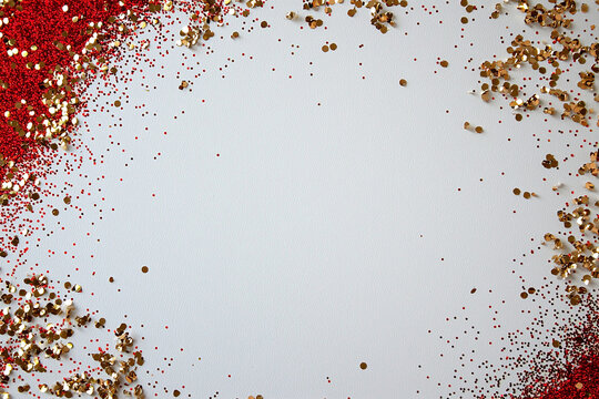 clean white canvas adorned with bold red borders and scattered gold and red glitter creates vibrant and festive atmosphere, perfect for celebrations