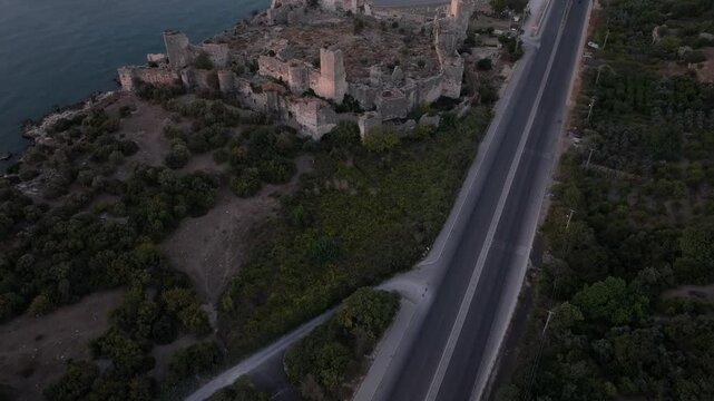 Aerial view of ancient Antik Kiz Kalesi fortress at sunrise over the Mediterranean Sea, Kizkalesi, Turkey.