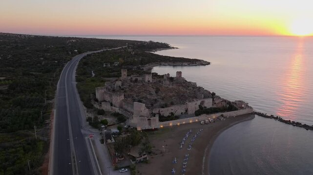 Aerial view of Antik Kiz Kalesi at sunrise over the tranquil Mediterranean Sea, Kizkalesi, Turkey.