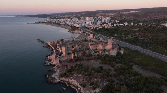 Aerial view of antik kiz kalesi at sunrise overlooking the beautiful mediterranean sea, Kizkalesi, Turkey.