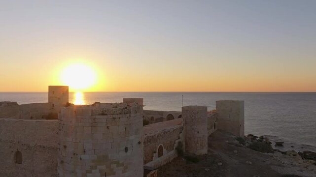Aerial view of maiden castle at sunrise overlooking the serene mediterranean sea, Kizkalesi, Turkey.