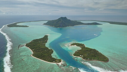 Breathtaking aerial view of Maupiti island, French Polynesia, showcasing lush greenery, turquoise lagoon, coral reef and vast expanse pacific ocean. Remote wild nature paradise, exotic summer travel © Goinyk